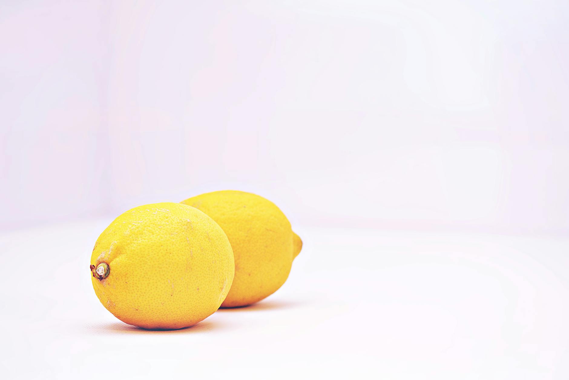 Woman holding colorful silicone vibrators with a thoughtful expression